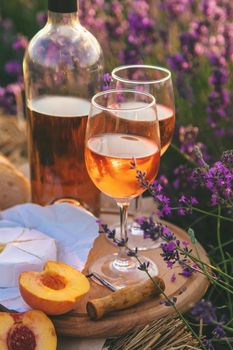 Wine in glasses. Picnic in the lavender field. Selective focus. Nature.