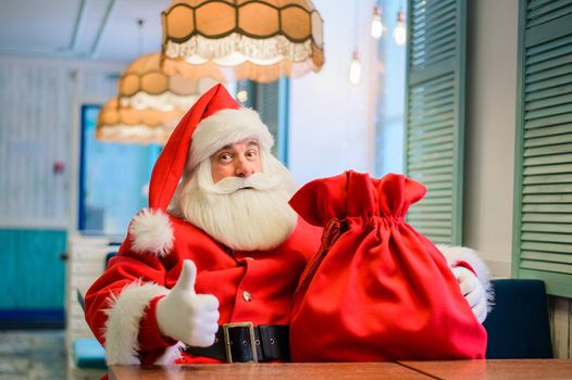 Friendly santa claus in a cafe