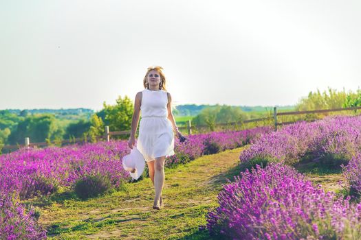 Woman in summer lavender field. Selective focus. Nature.
