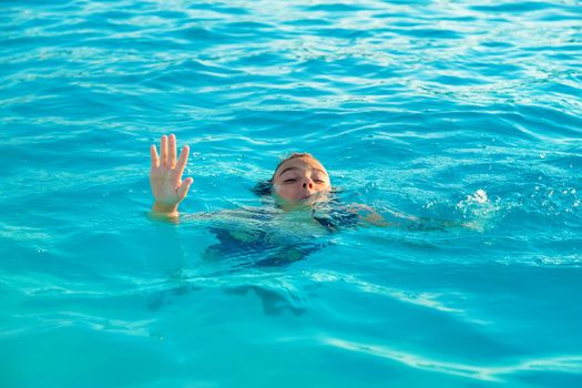 The child is drowning in water. Selective focus. Kid.