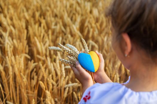 Child in a wheat field. In vyshyvanka, the concept of the Independence Day of Ukraine. Selective focus. Kid.