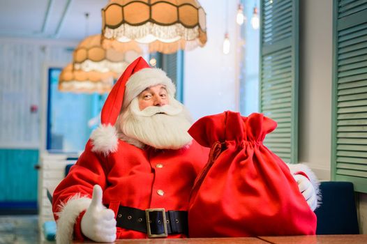 Friendly santa claus in a cafe