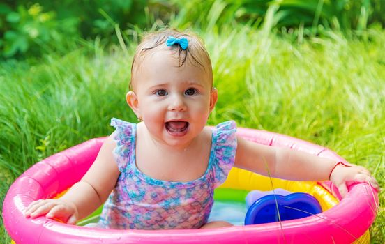 Baby swims in the pool. Selective focus. Child.