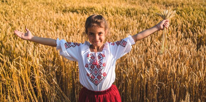 Child in a wheat field. In vyshyvanka, the concept of the Independence Day of Ukraine. Selective focus. Kid.