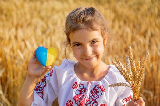 Child in a wheat field. In vyshyvanka, the concept of the Independence Day of Ukraine. Selective focus. Kid.