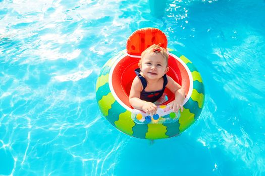 Baby swims in a circle in the pool. Selective focus. Nature.