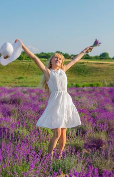 Woman with hat in lavender field. Selective focus. Nature.
