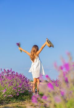 A child in a lavender field. Selective focus. Nature.