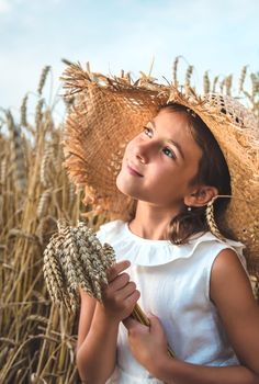 A child in a wheat field. Selective focus. Nature.