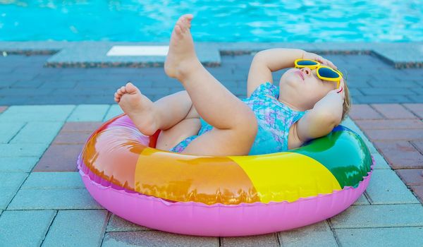 Baby with a circle near the pool. Selective focus. Child.