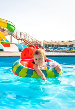 Baby swims in a circle in the pool. Selective focus. Nature.