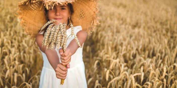 A child in a wheat field. Selective focus. Nature.
