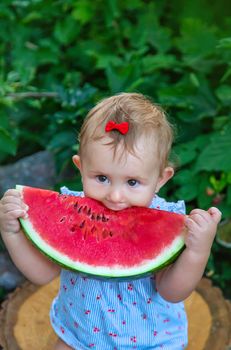 Baby eats watermelon in summer. Selective focus. Food.