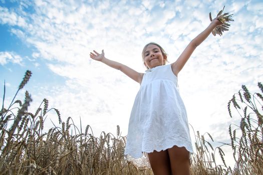 A child in a wheat field. Selective focus. Nature.