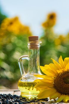 Sunflower oil in a bottle on the field. Selective focus. Nature.