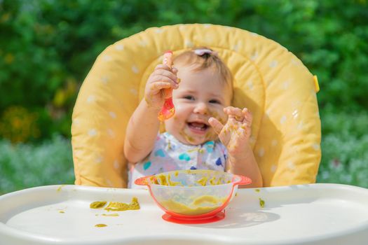 Baby is eating vegetable puree. Selective focus. Child.