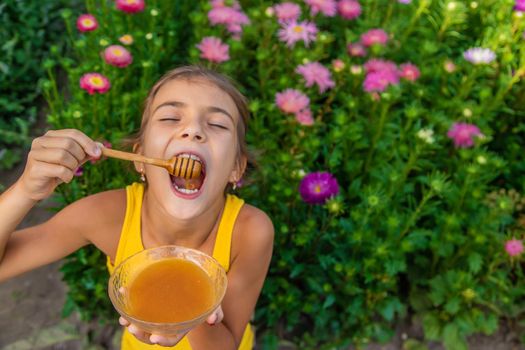 The child eats flower honey. Selective focus. Nature.