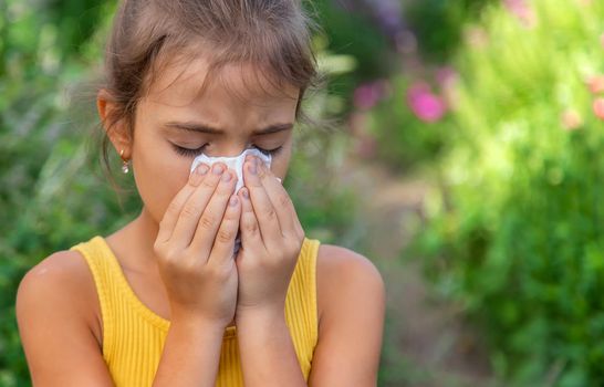 The child is seasonal allergy to flowers. Selective focus. Kid.