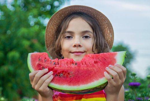 The child eats watermelon in the summer. Selective focus. Baby.