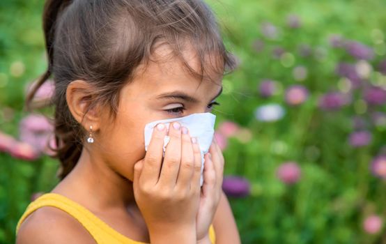 The child is seasonal allergy to flowers. Selective focus. Kid.