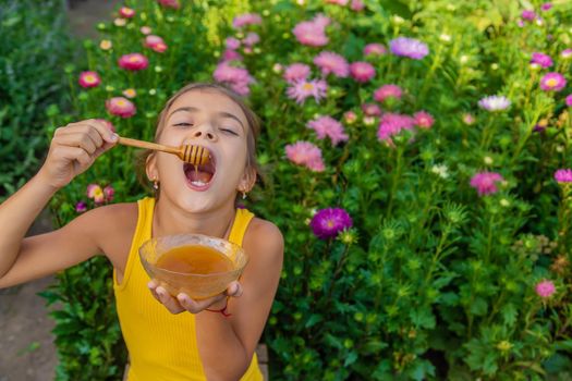 The child eats flower honey. Selective focus. Nature.