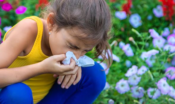 The child is seasonal allergy to flowers. Selective focus. Kid.