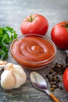 Ketchup in a bowl on the table. Selective focus. Food.