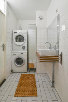 Interior of contemporary bathroom with shower and sink in minimal style in flat