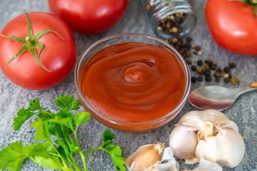 Ketchup in a bowl on the table. Selective focus. Food.