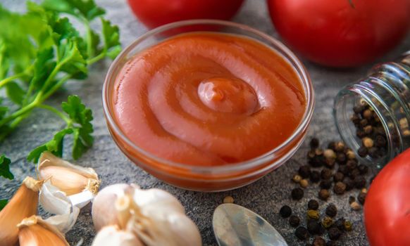 Ketchup in a bowl on the table. Selective focus. Food.