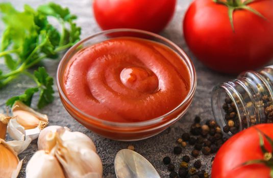 Ketchup in a bowl on the table. Selective focus. Food.