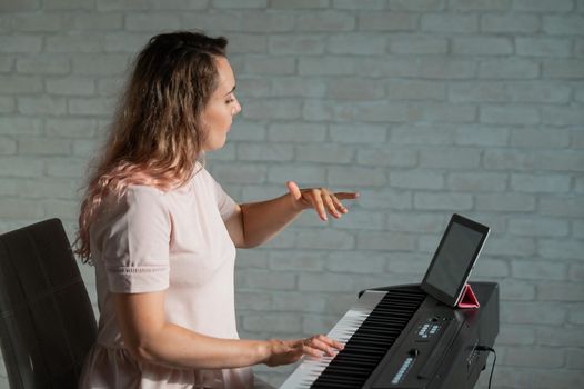 Female singing teacher at online lesson on digital tablet.