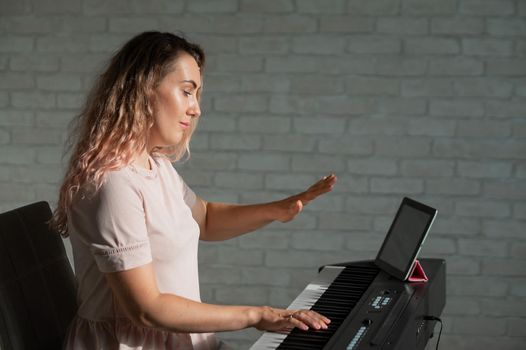 Female singing teacher at online lesson on digital tablet.