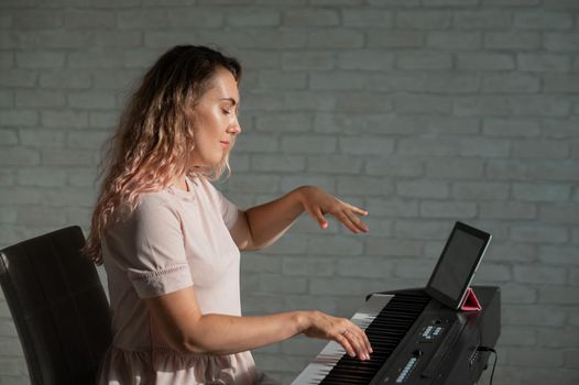 Female singing teacher at online lesson on digital tablet.