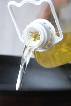 Pouring vegetable oil into frying pan