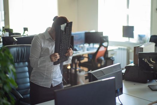 A woman freaks out and gets depressed from a mistake and breaks the keyboard on the monitor. Female manager gets angry and crashes a computer. Office clerk is stressed at work. Unstable psyche