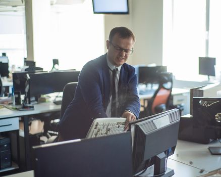 A man freaks out and gets depressed from a mistake and breaks the keyboard on the monitor. The male manager is angry and crashes the computer. Office clerk is stressed at work. Unstable psyche