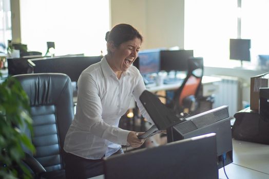 A woman freaks out and gets depressed from a mistake and breaks the keyboard on the monitor. Female manager gets angry and crashes a computer. Office clerk is stressed at work. Unstable psyche