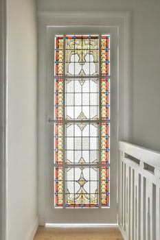 Spacious bright stained glass window with beautiful painted patterns