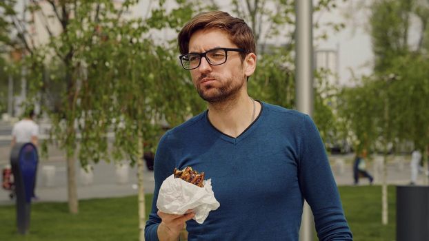 Busy Business man Lunch Eating snack. Employee Taking Break Work. Eat Snack walking .Cheerful Business man Having Lunch Break Outdoor. Hungry Man Eat. Hurried young man have lunch meal.