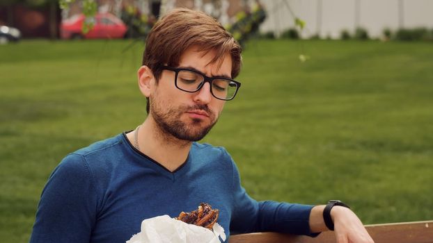 Employee Taking Break Work. Eat Snack walking .Cheerful Business man Having Lunch Break Outdoor. Hungry Man Eat. Enjoying food. Smells good snacks.