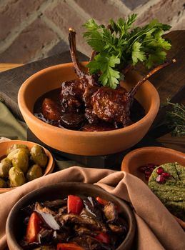 A vertical shot of a tomahawk steak and appetizers