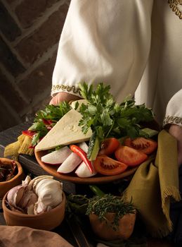 A vertical shot of a waitress presenting a appetizer dish