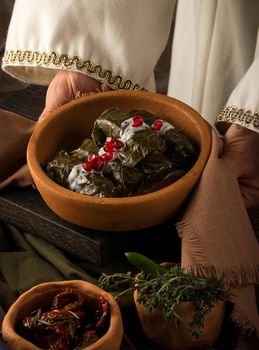 A close up shot of a dolma covered in grape leaves