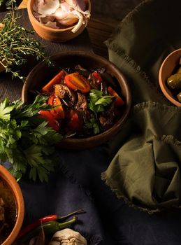 A vertical shot of a chef serving a gourmet salad dish