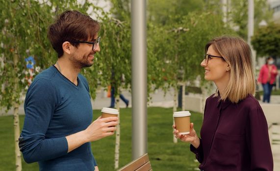 Smiling caucasian businesswoman and man Funny Coversation talking. Coworkers friendly discussion during lunch time. Happy Friends meeting.