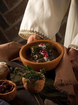 A close up shot of a dolma covered in grape leaves