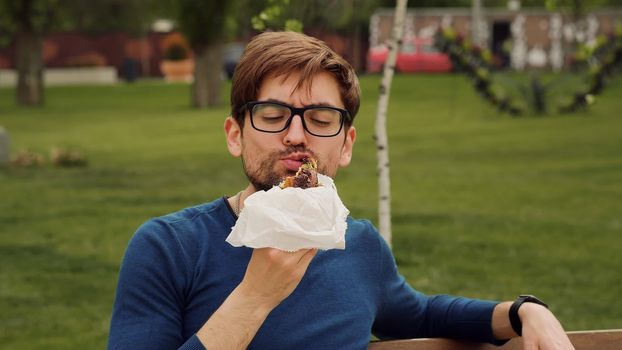 Busy Business man Lunch Eating snack. Eat Snack walking .Cheerful Business man Having Lunch Break Outdoor. Hungry Man Eat. Enjoying food. Smells good snacks.