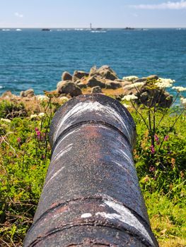 View down a cannon barrel at the L'Eree Battery, overlooking Les Hanois Lighthouse, Guernsey, Channel Islands