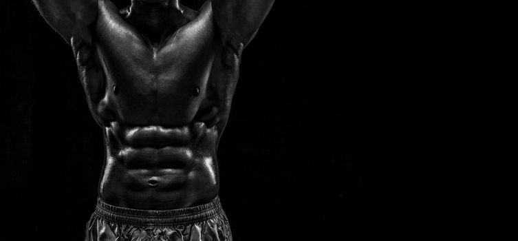 Part of a man's body on a dark background with copyspace. Studio shot on black background.